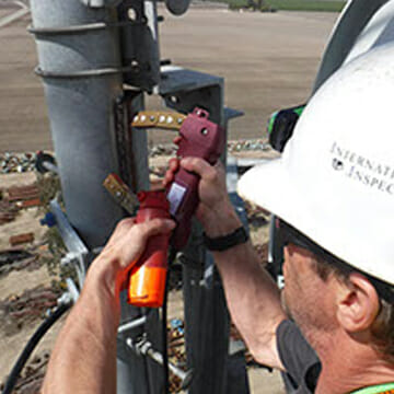 Rope Access Expert Performing Magnetic Particle Testing on Client Structure