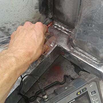 Technician Assessing Structural Integrity of Newly Installed Modification to Client Equipment