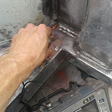 Technician Assessing Structural Integrity of Newly Installed Modification to Client Equipment