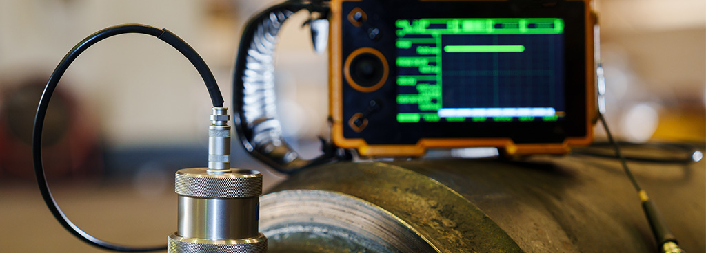 Technician Performing Ultrasonic Testing on a Welded Component of a Client Asset